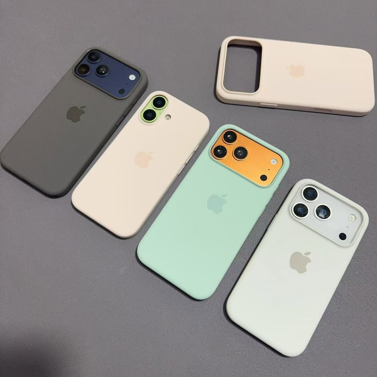 Side view of assorted iPhone 17 silicone cases and button covers