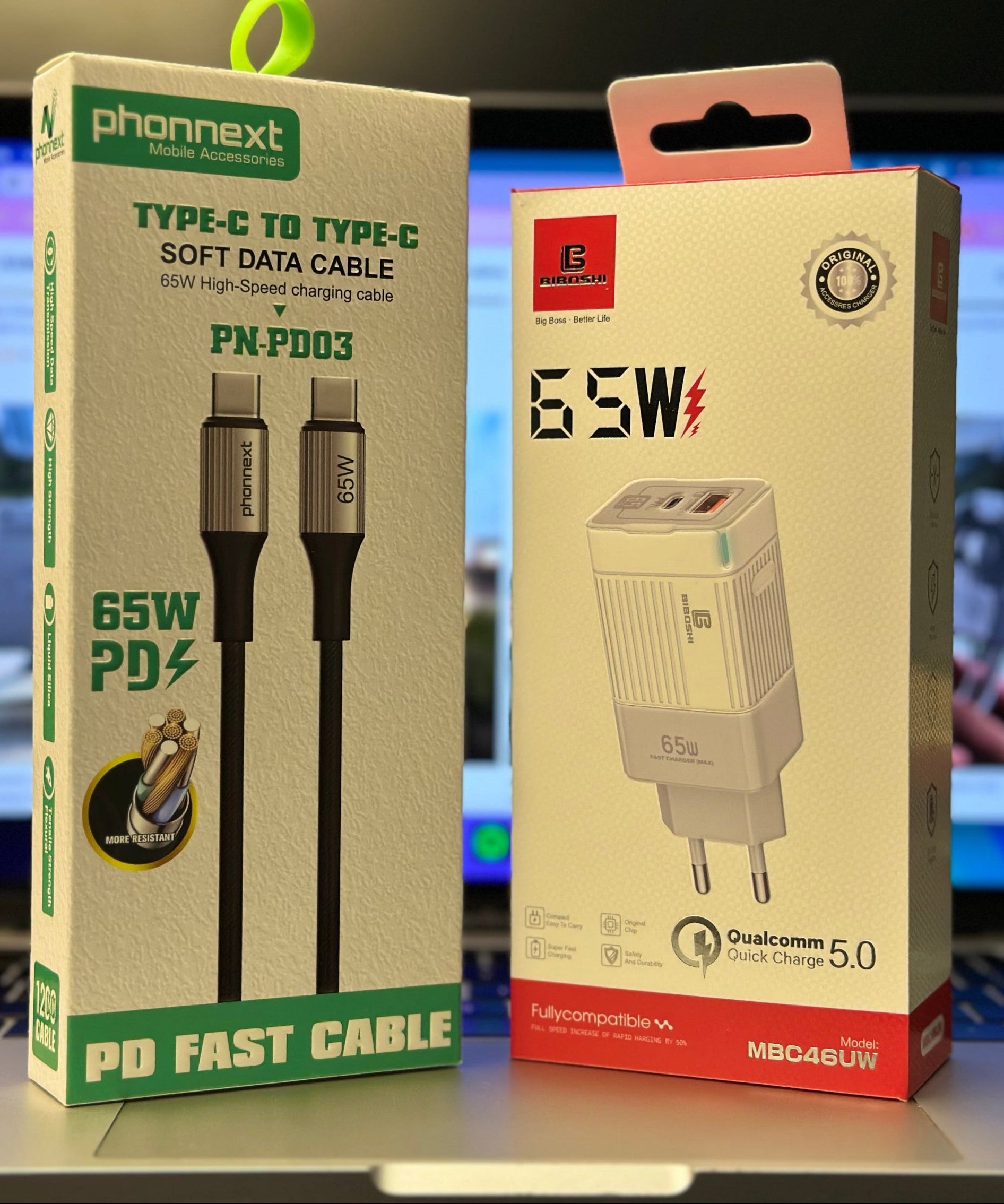 Two electronic product boxes on a desk with a blurred background