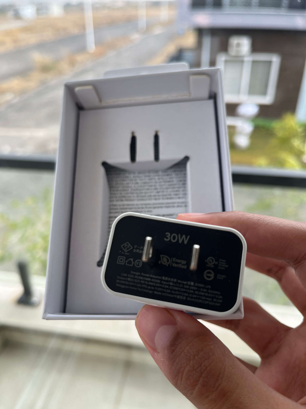 30W USB-C charger unboxed with underside label visible